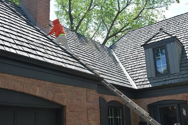 Man working on a cedar shingle roof