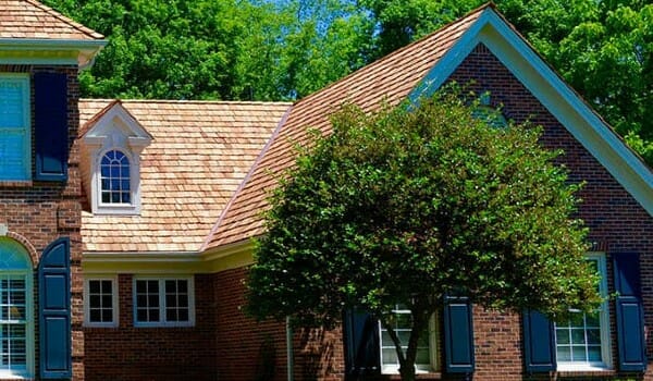 Large Brick home with cedar shingle roof