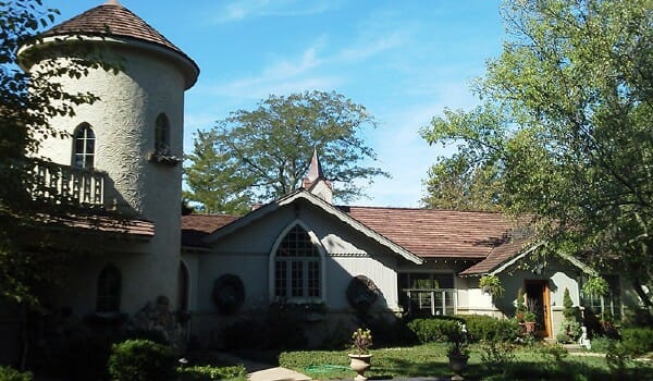 Beautiful home with nice roof surrounded by trees