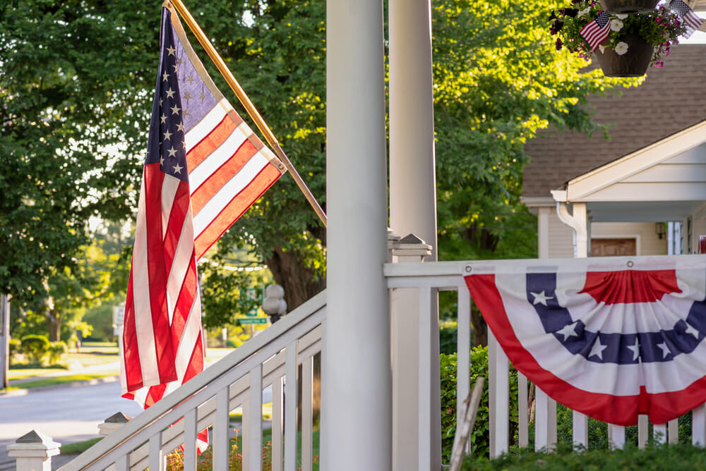 American flag waving outside home on main street in downtown barrington, IL